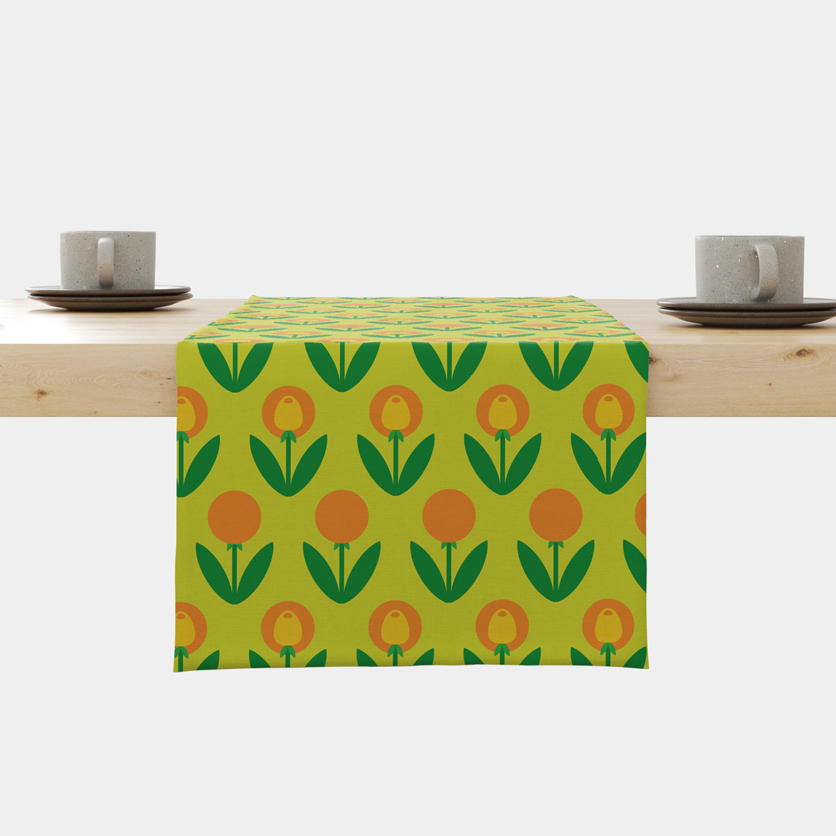 Bieżnik z wzorem retro tulipanów w zielono-pomarańczowej kolorystyce rozłożony na jasnym stole
