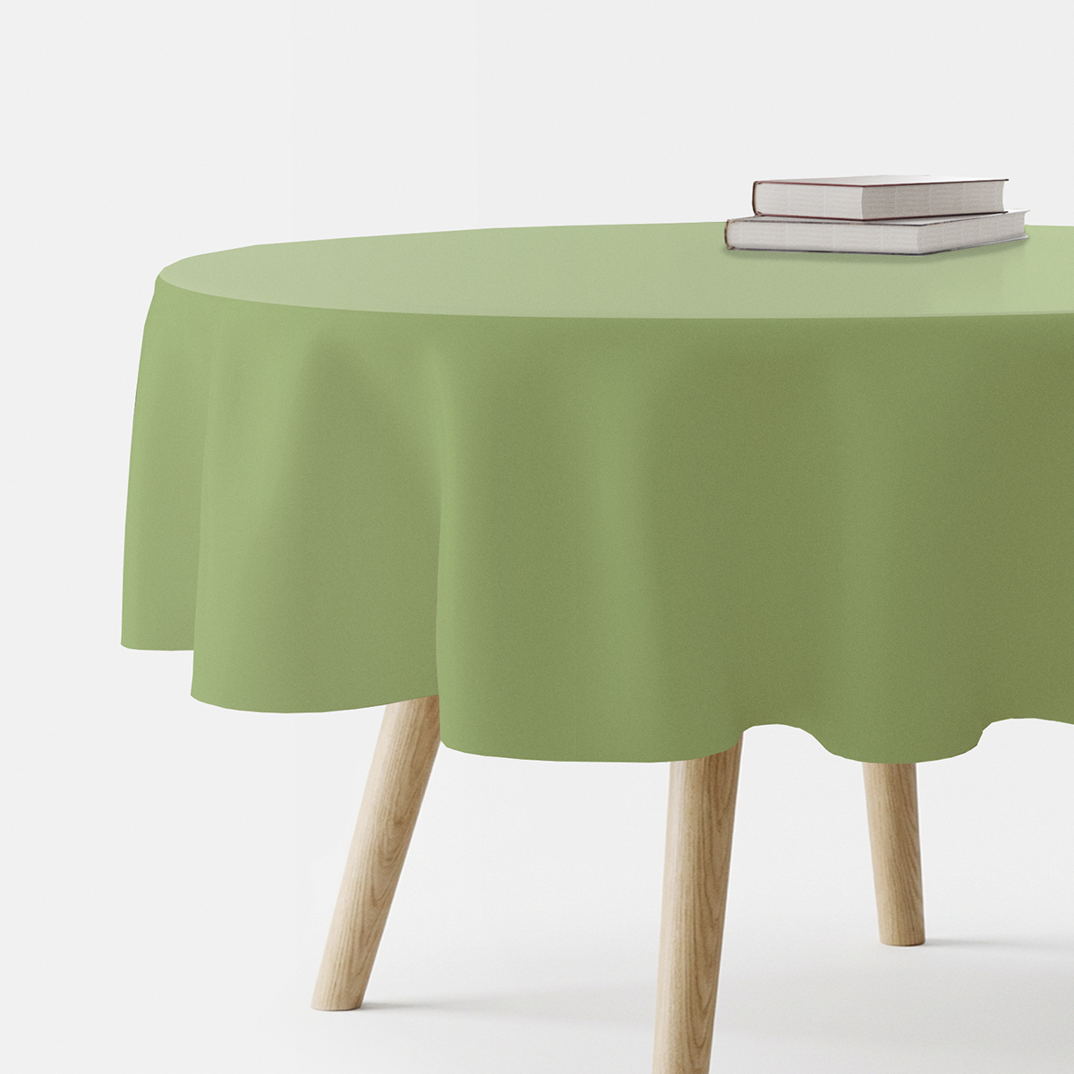 okrągły stół nakryty gładkim miętowym obrusem złożone książki na blacie