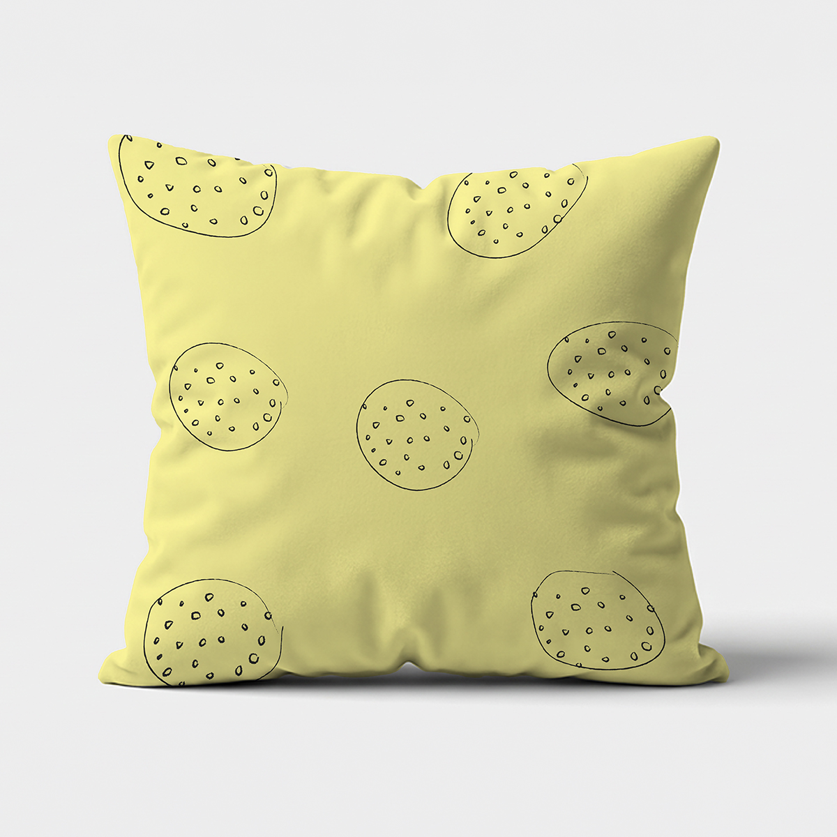Główne ujęcie poduszki w jasnożółtym tle z ręcznie rysowanymi okręgami i drobnymi kropeczkami