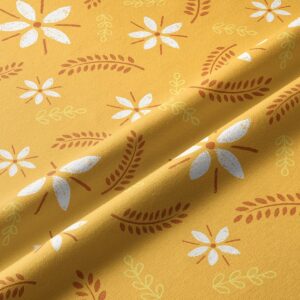 Zbliżenie tkaniny pokazujące fakturę oraz rysunek białych kwiatów i brązowych listków