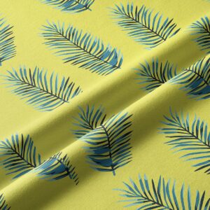 Zbliżenie na fakturę tkaniny i granatowo-niebieskie liście na limonkowym tle